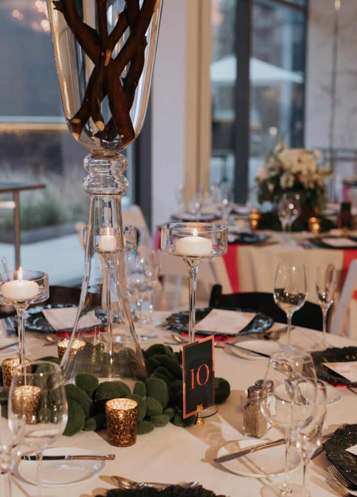 Carats & Cake Feature, Nomi Art Gallery Chicago wedding reception featuring black and white resin folding chairs along with sea sponge dark green chargers from Tablescapes Chicago