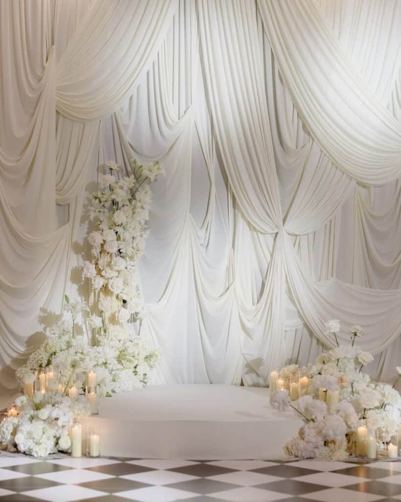All-white wedding with checkered dancefloor and gorgeous drapery