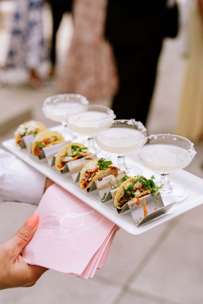 Passed appetizer tray with stainless steel taco holders and mini margaritas.